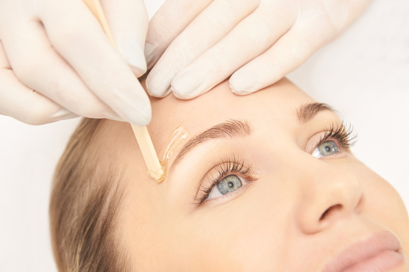 Woman Having Her Eyebrow Waxed Up Close